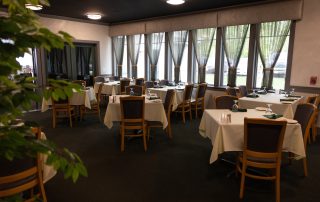 Elegant banquet room at Terrazza Greenfield with white linen tables set for a private event