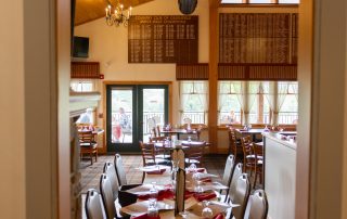 Framed doorway view of Terrazza Greenfield's dining room with set tables at Country Club of Greenfield