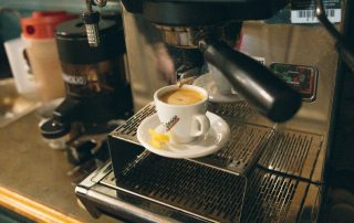Close-up of espresso brewing from machine into cup at Terrazza Greenfield