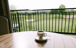 Espresso on the outdoor deck table overlooking the golf course green at Terrazza Greenfield