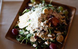 Mixed greens salad with feta cheese, sliced apples, grapes, cranberries, and almonds served at Terrazza Greenfield