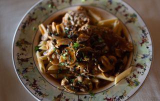 Penne pasta topped with mushrooms, and rich brown sauce served at Terrazza Greenfield