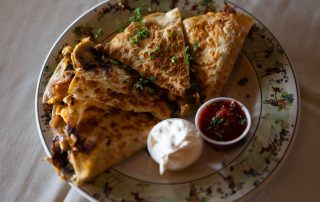 Grilled quesadilla with sour cream and salsa served at Terrazza Greenfield