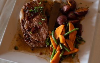 Grilled steak with roasted potatoes, carrots, and green beans served at Terrazza Greenfield