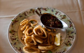 Crispy fried calamari served with dipping sauce and lemon at Terrazza Greenfield