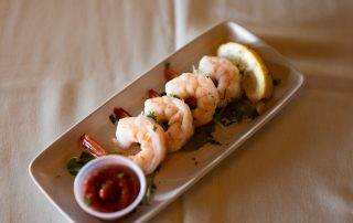 Shrimp cocktail served with dipping sauce and lemon at Terrazza Greenfield restaurant
