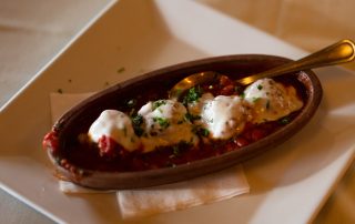 Baked dish topped with melted cheese in tomato sauce served at Terrazza Greenfield restaurant